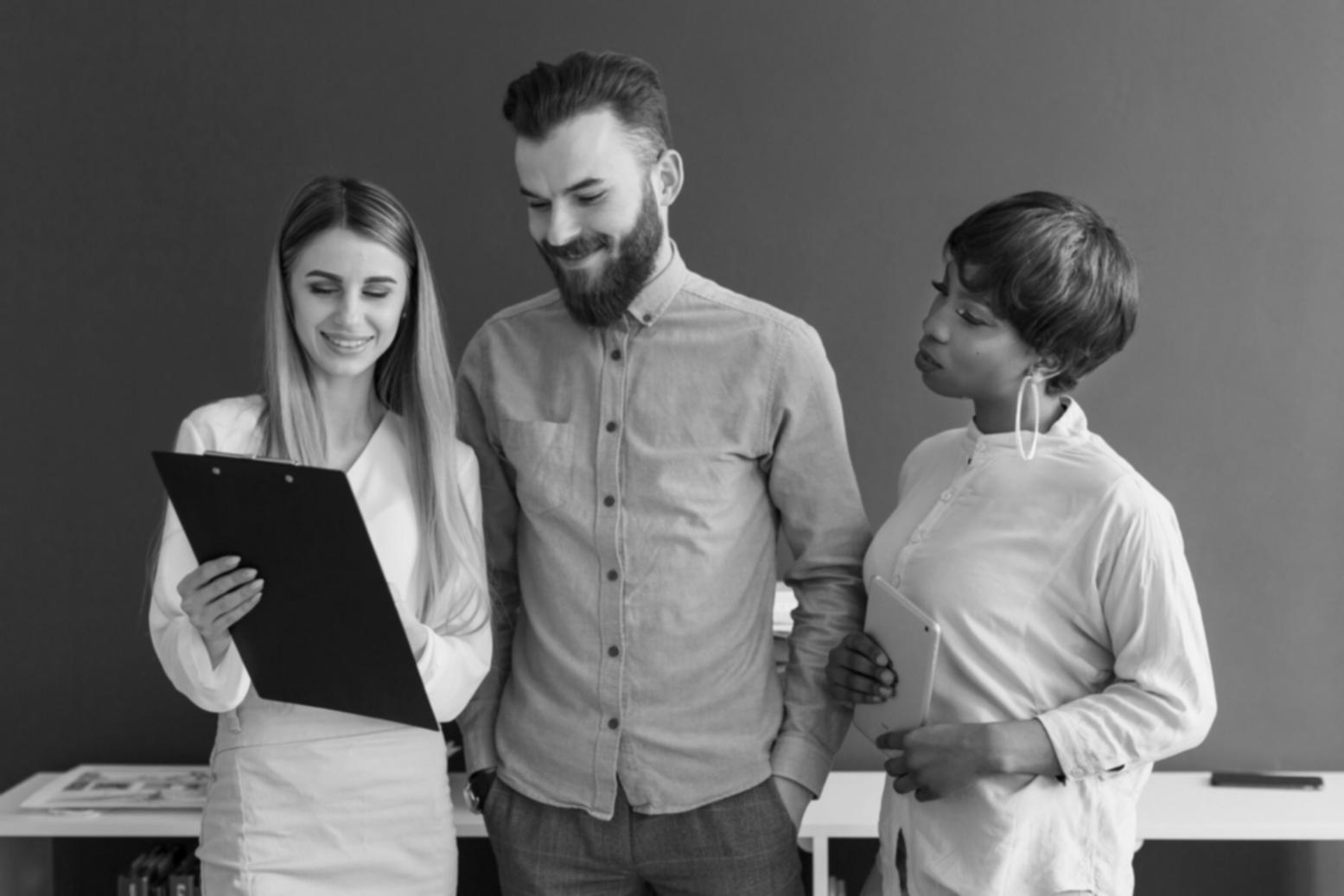 UX designer reviewing financial app interface designs on tablet and desktop screens