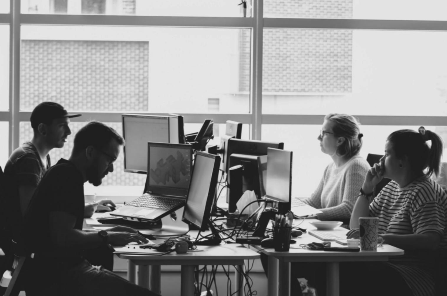 Students working together on budget analysis software in modern classroom