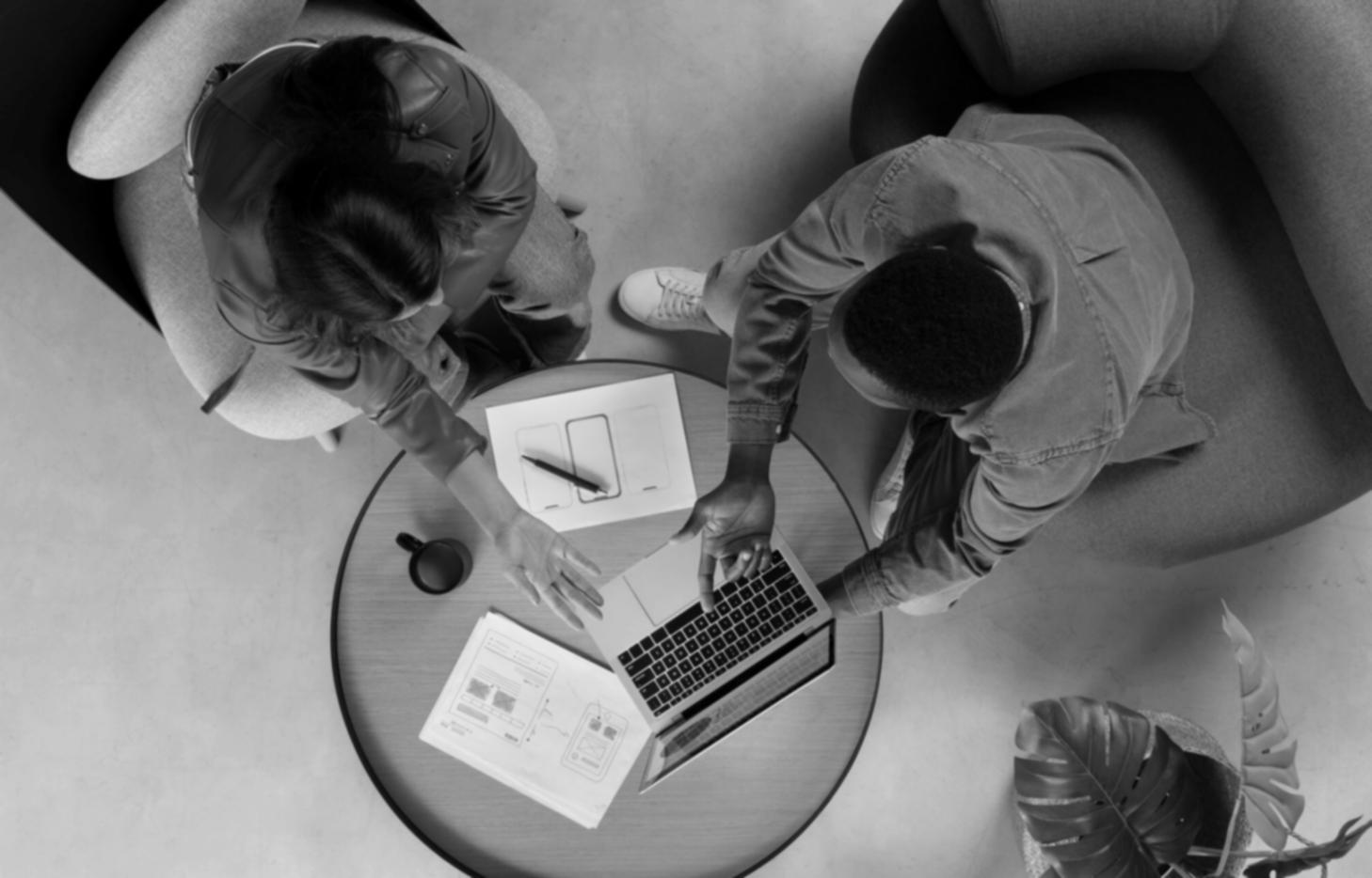 Team collaboration session discussing budget management features